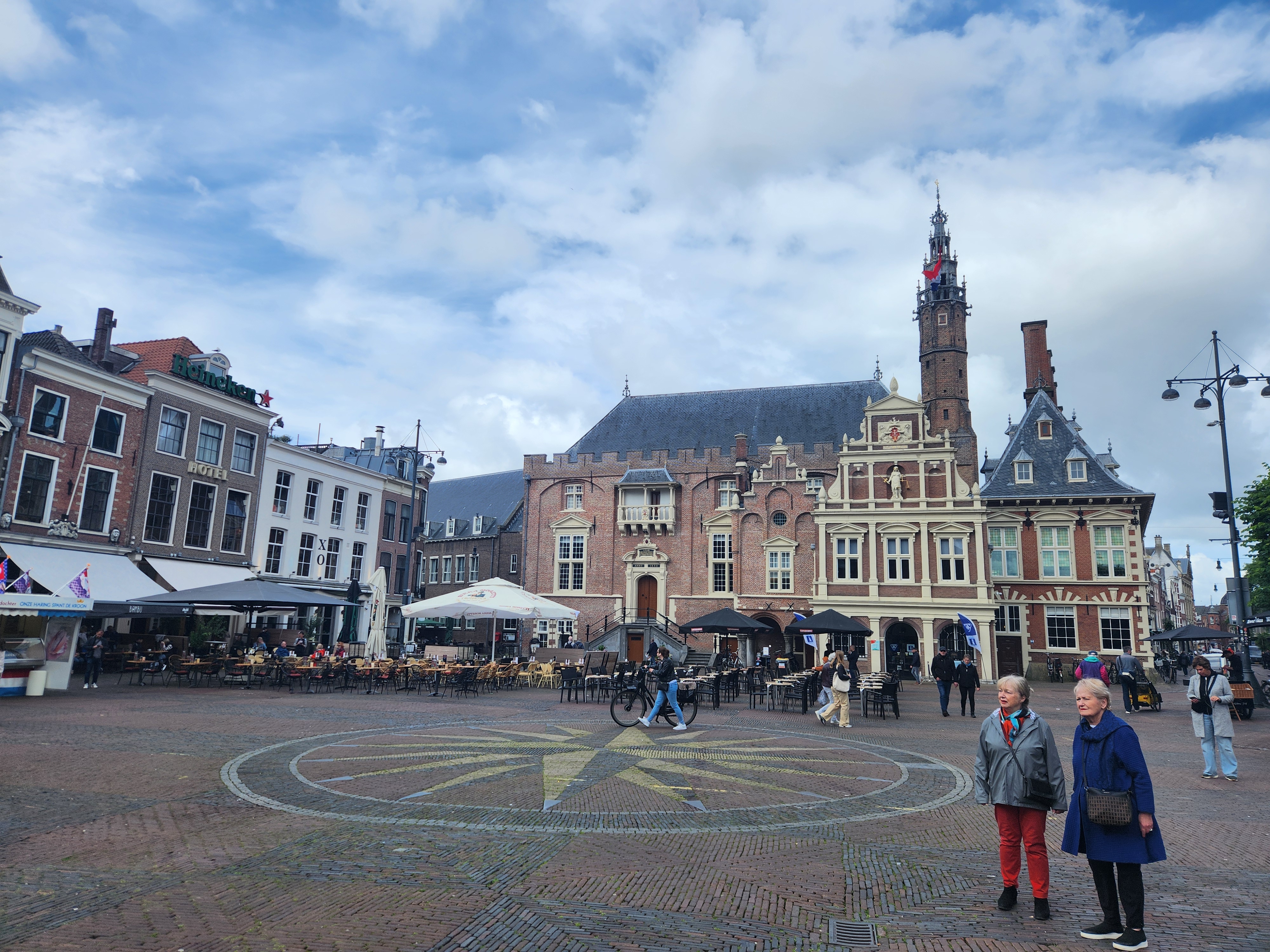 The square at Haarlem, there is a large townhall and other old buildings, the square is decorative brick