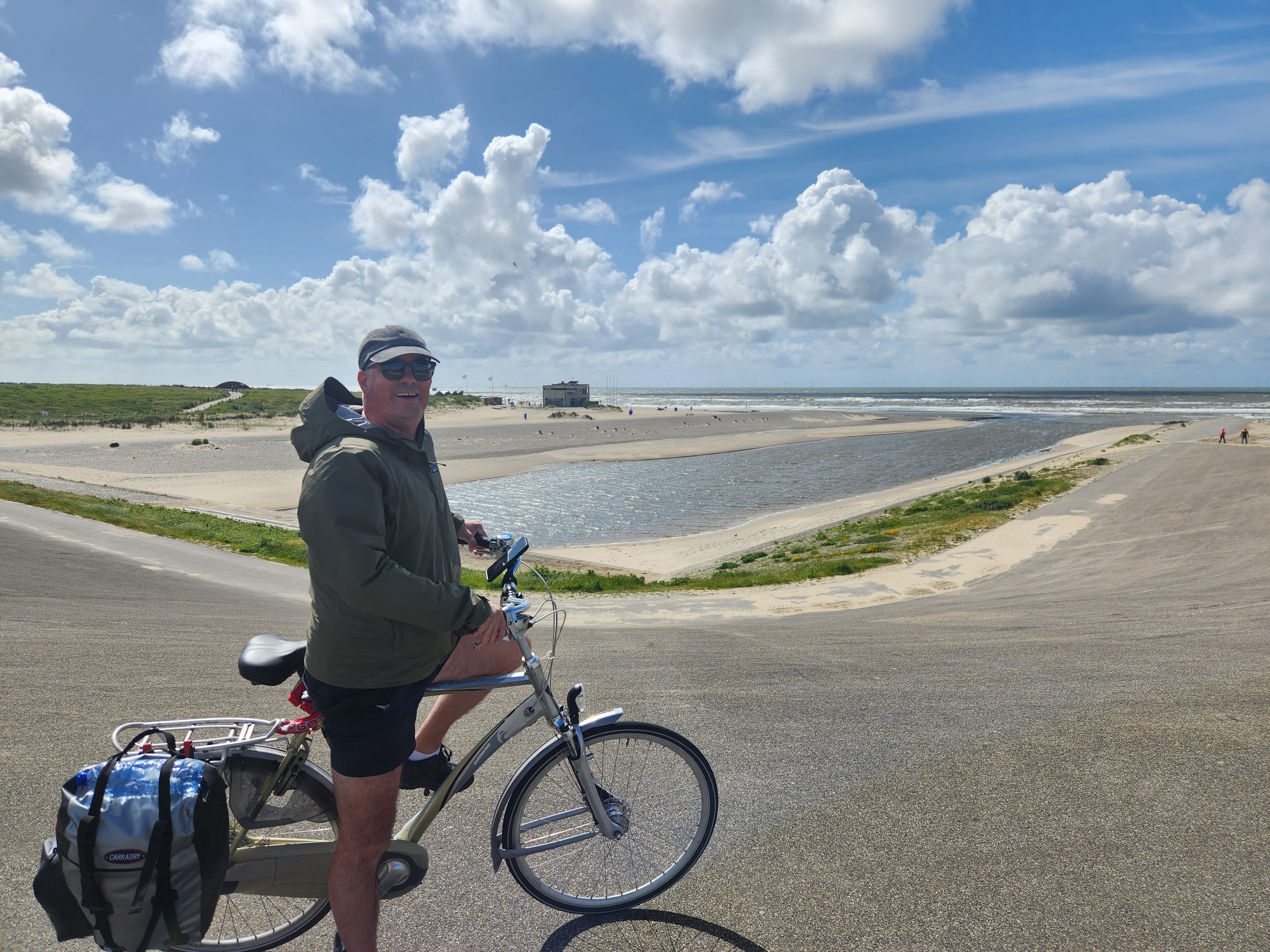 The North sea, there is a river trench heading to the sea, Mark is in the foreground on his bike